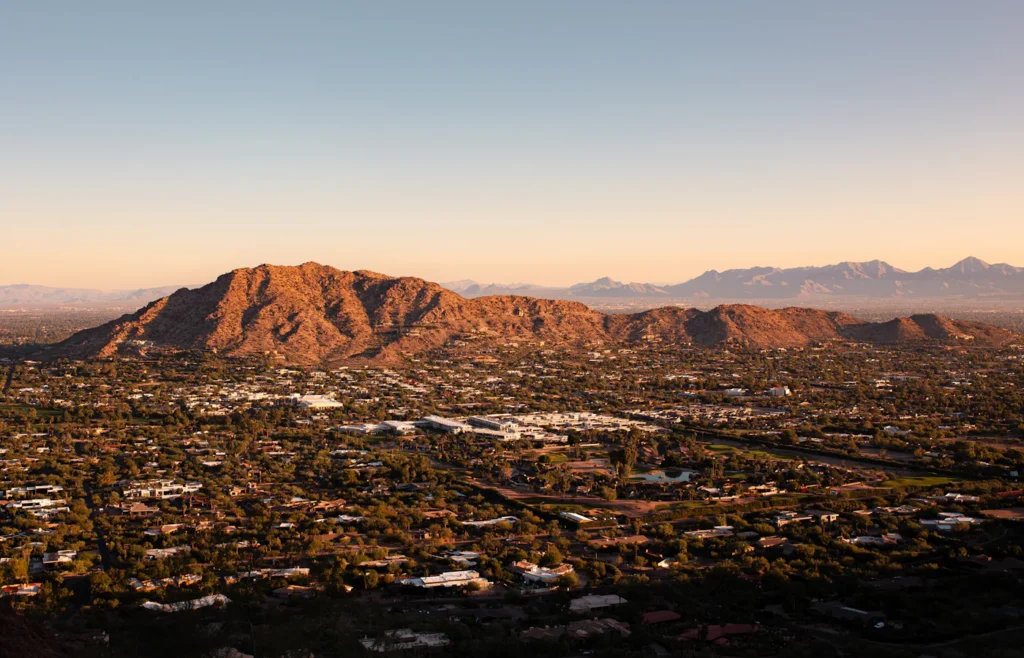 Aerial view of an Arizona city with mountains in the background